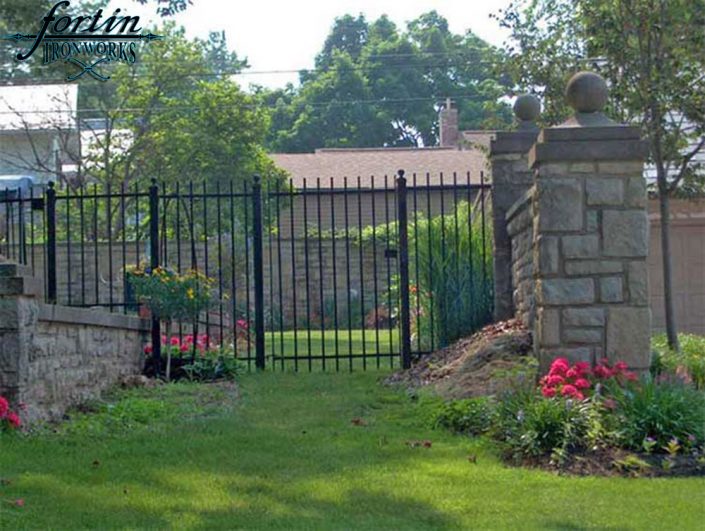 stone pillar attached walk through gate and fence