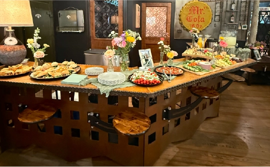 Catering and appetizer spread displayed on a custom industrial metal bar table at the Fortin Ironworks Event Lounge in Grandview Columbus Ohio